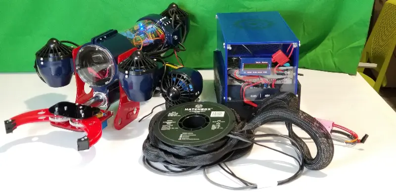 Photo of underwater robot next to battery pack
